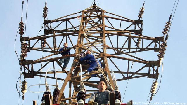 Albanian power utility workers repair th