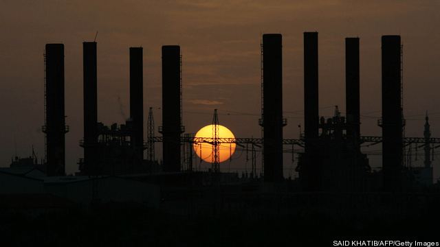 The sun sets behind the main Palestinian